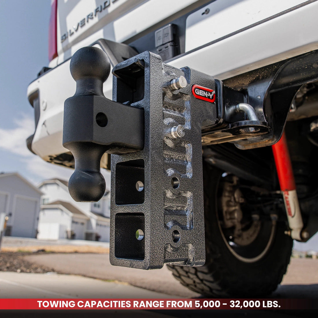 GEN-Y MEGA-DUTY adjustable drop hitch with dual-ball mount installed on a pickup truck, with a banner reading towing capacities range from 5,000 to 32,000 pounds